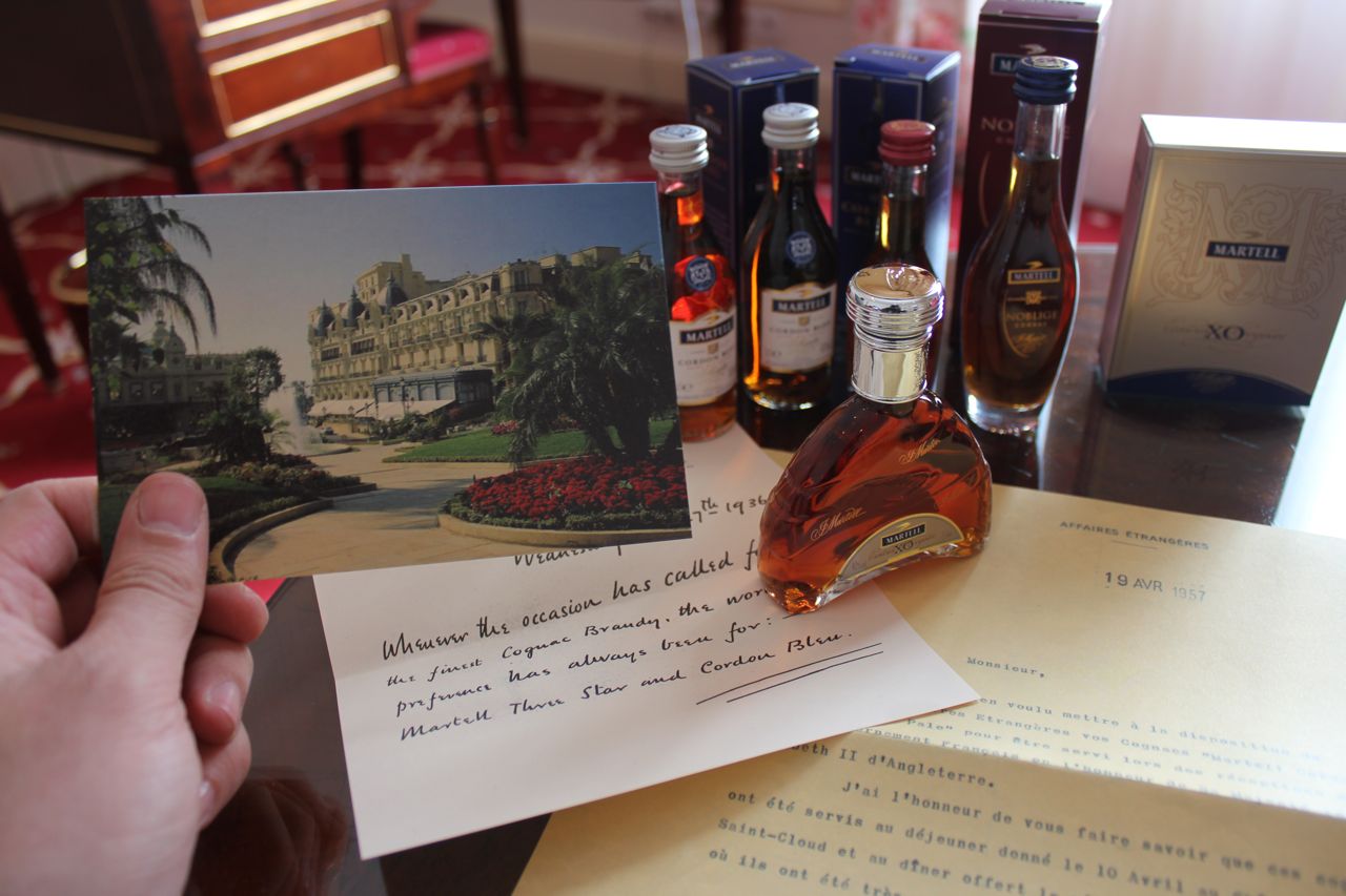 An old post card, some letters, and miniature Martell bottles