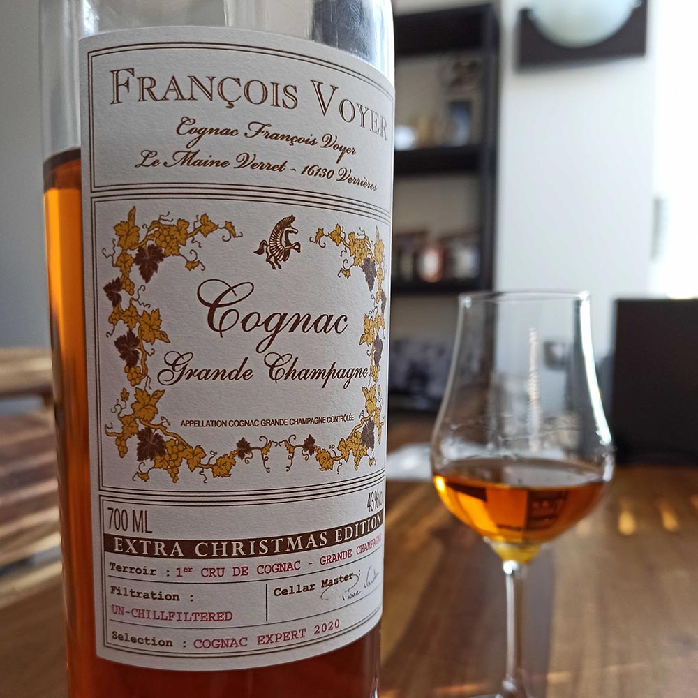 Francois Voyer Christmas Cognac bottle in foreground, glass in background