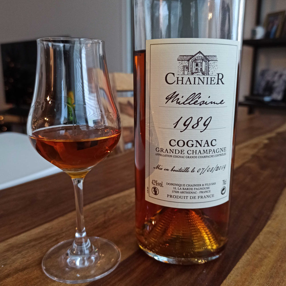 Chainier Millesime 1989 bottle next to glass filled with this cognac